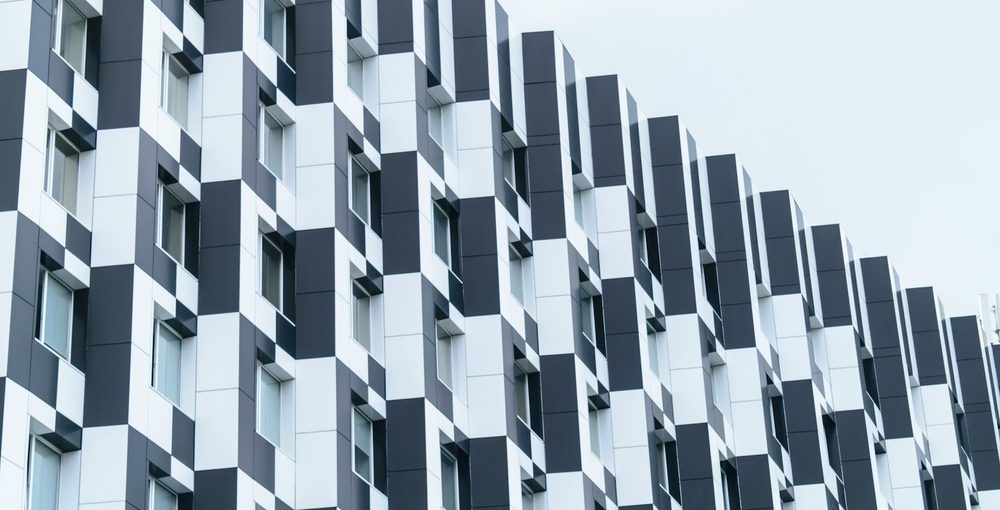 A facade of identical repeating modules receding into the distance