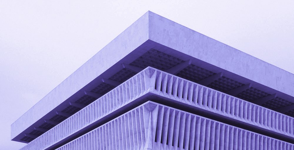 A tiered concrete roofline, in violet tones