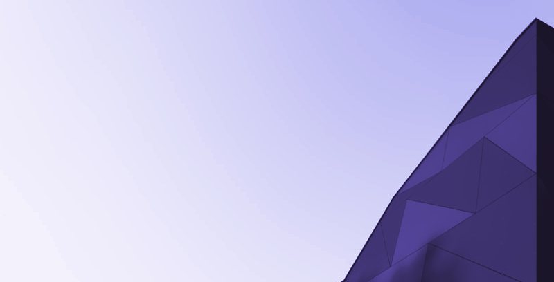 An angular facade edge against a pale sky, in violet tones